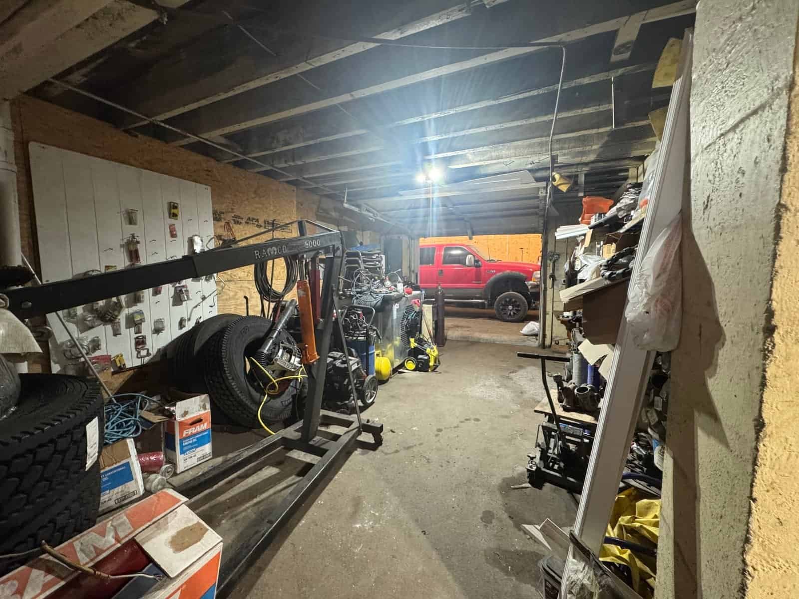 Interior view of a workshop showcasing organized storage of Cordura RE fabric rolls and tools on shelves and racks, with a focus on industrial-grade textile materials.