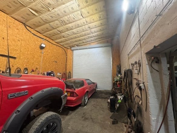 High-quality Cordura RE fabric used for industrial and outdoor applications, shown in a garage with vehicles and tools.