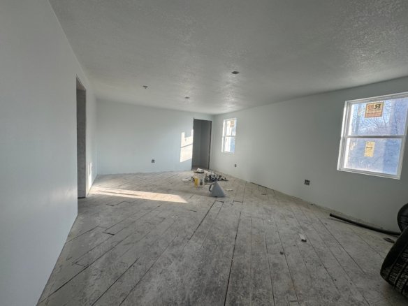 Interior room under construction with unfinished flooring and white walls, showcasing the use of durable Cordura RE fabric for renovation projects.