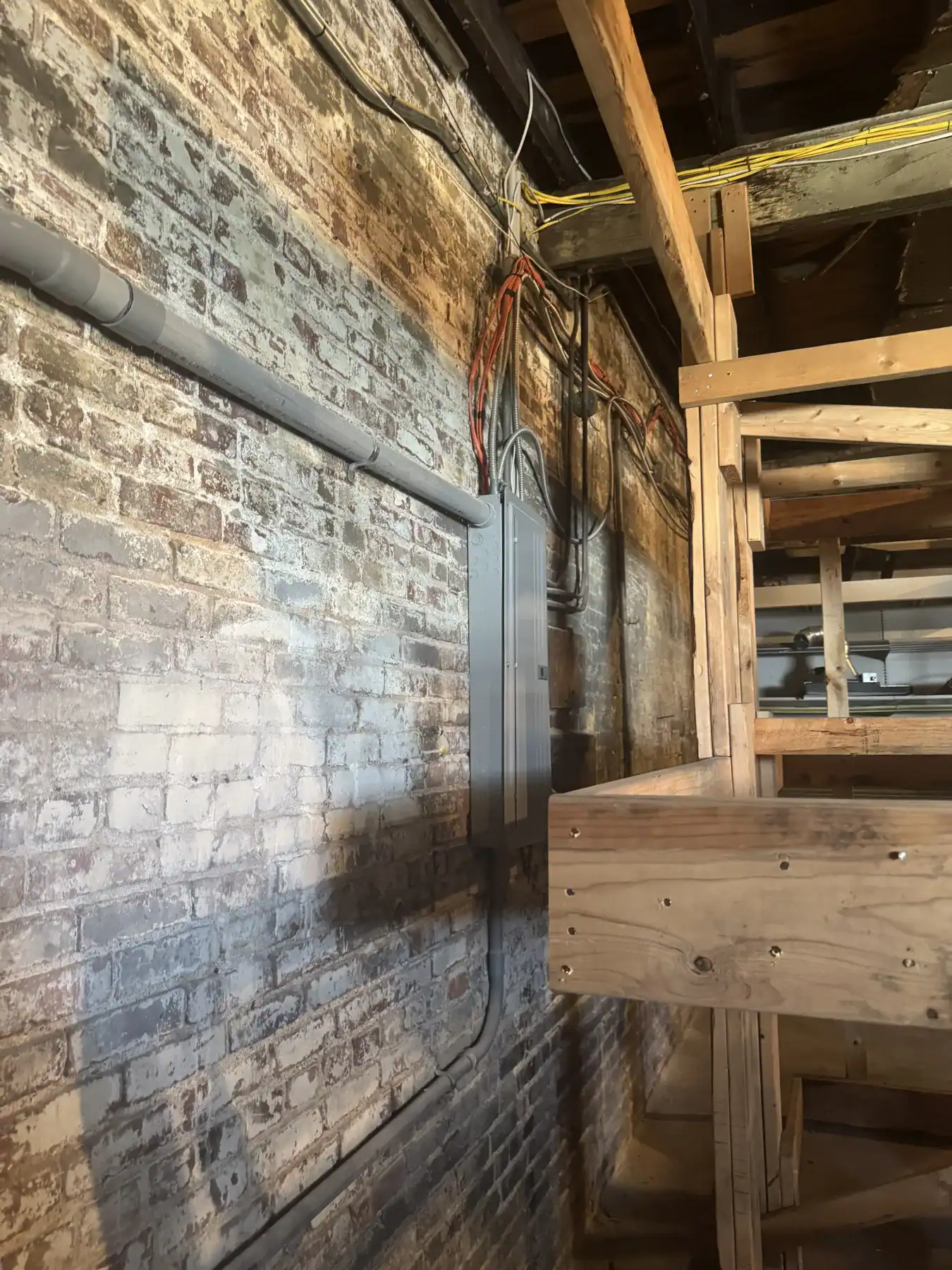 Industrial setting showcasing Cordura RE fabric used in construction with electrical wiring and wooden framework in a warehouse or workshop environment.