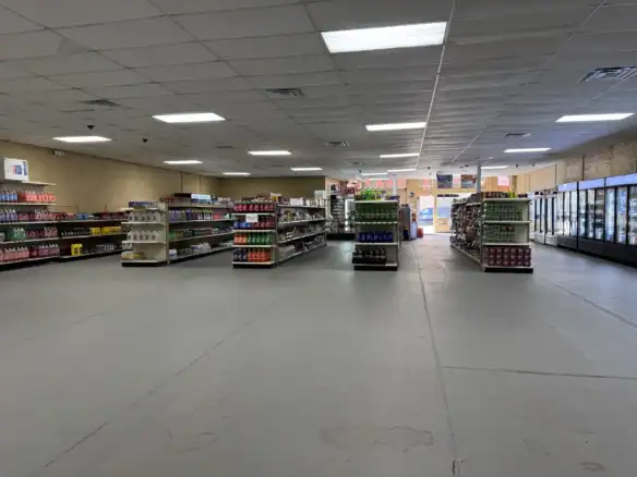 Interior view of a retail store showcasing shelves stocked with various products, highlighting the durability and versatility of Cordura RE fabric used in packaging and displays.