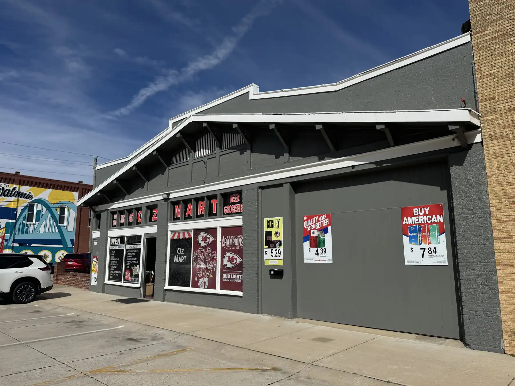 Exterior view of a retail store showcasing Cordura RE fabric products, with signage and storefront windows under a clear blue sky.