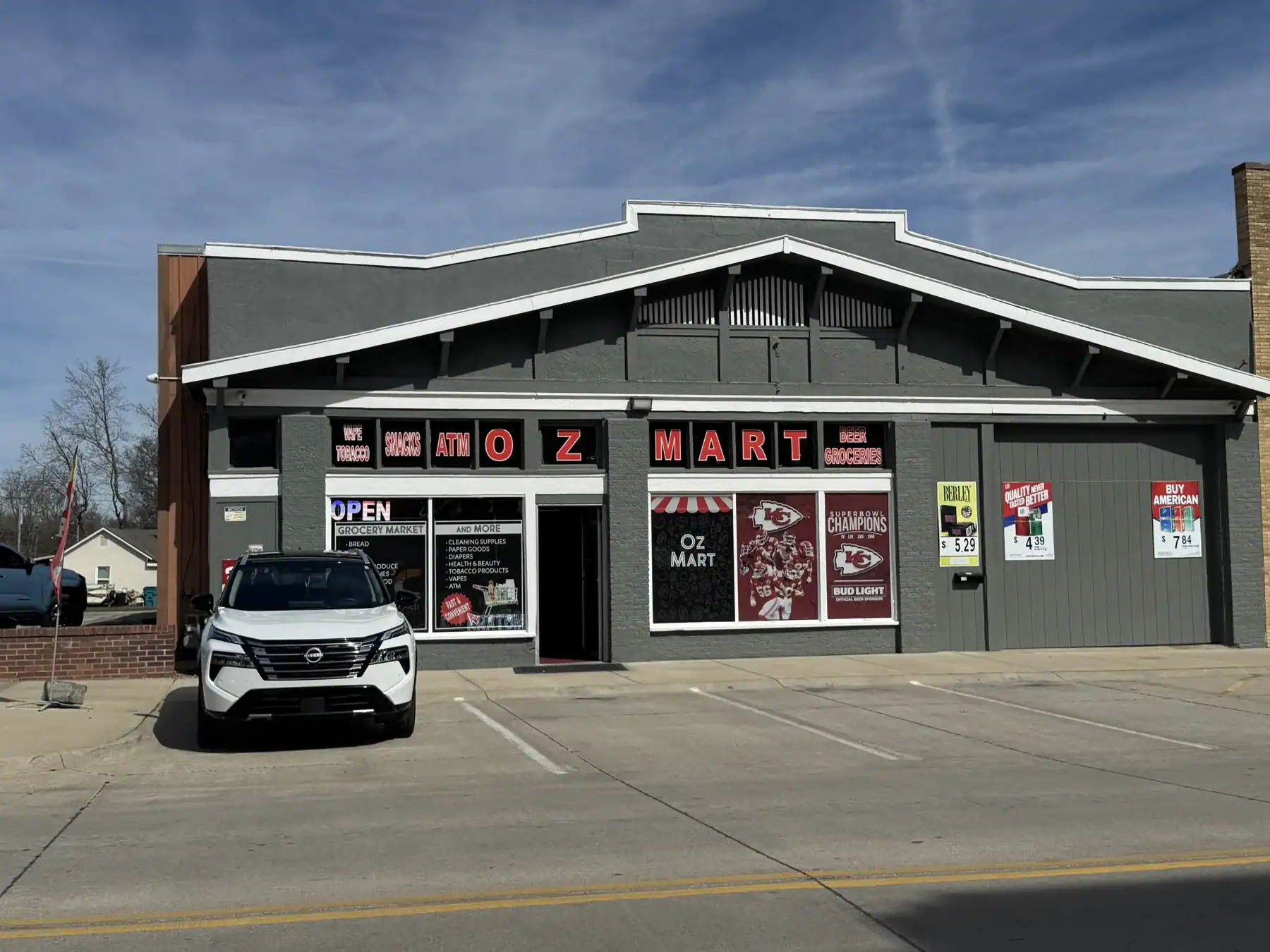 Cordura RE storefront with parking lot and vehicle in front, showcasing durable fabric exterior.